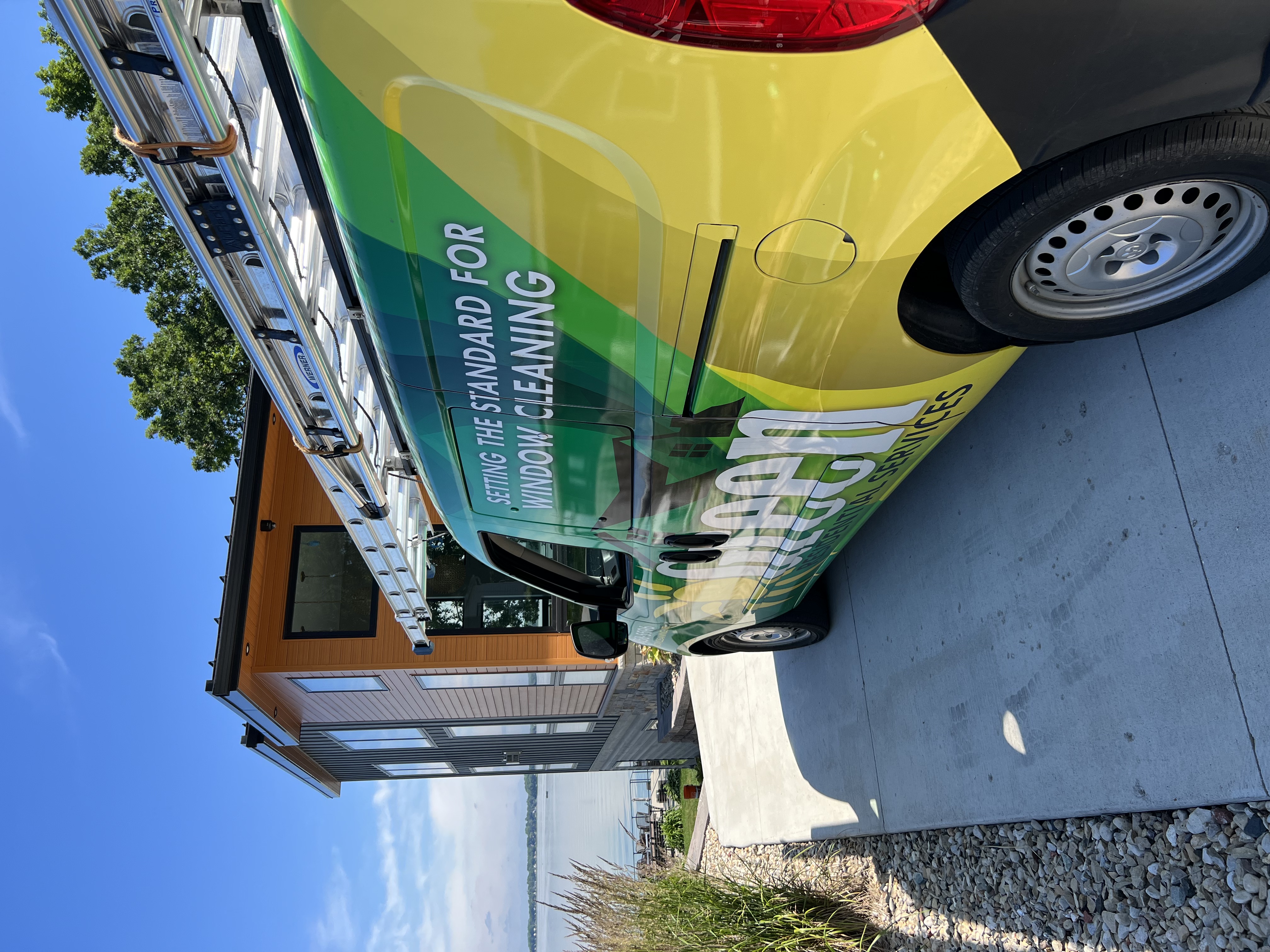 Green Window Cleaning service van at beautiful lakeside property