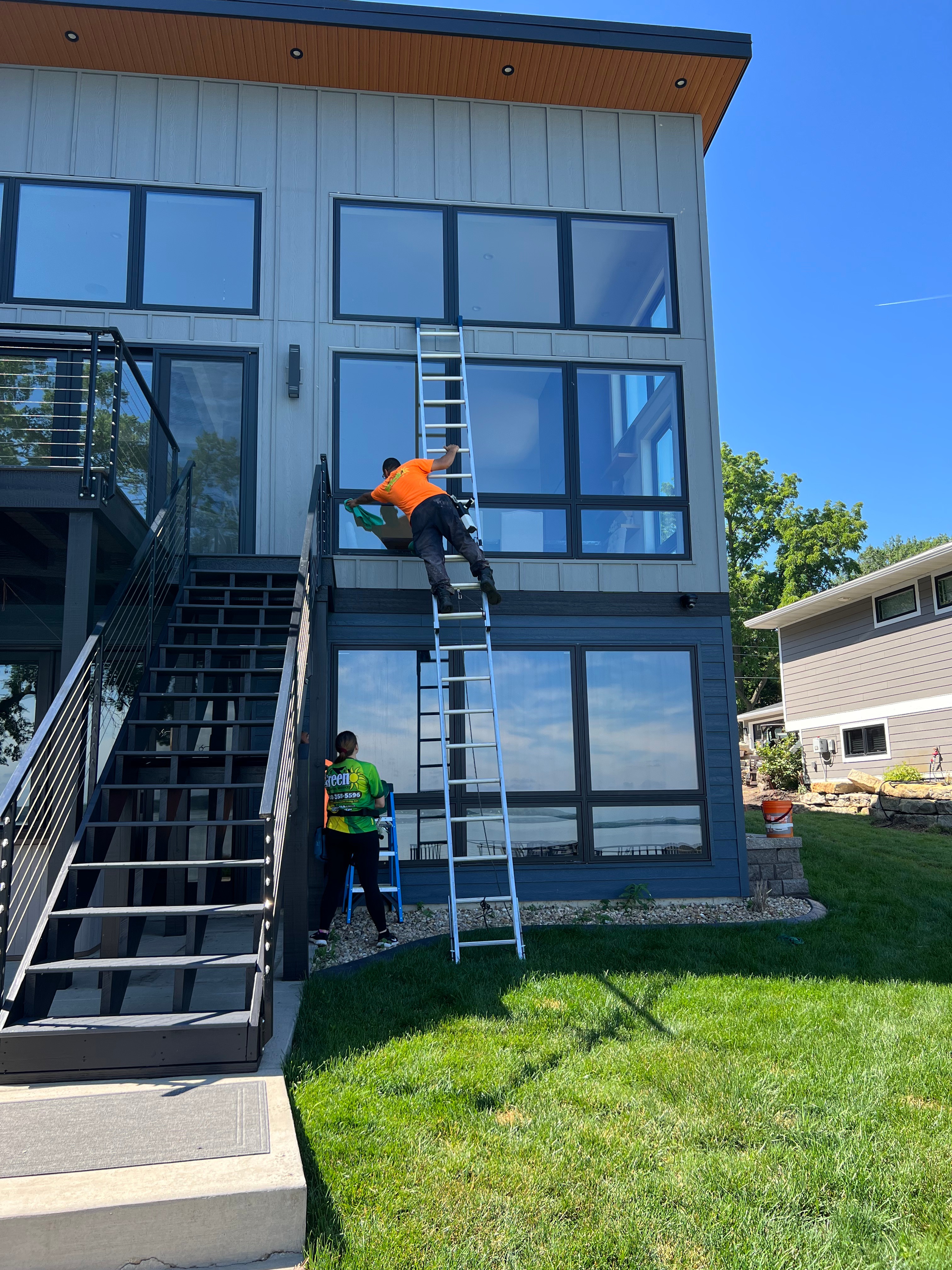 Team cleaning modern residential building exterior